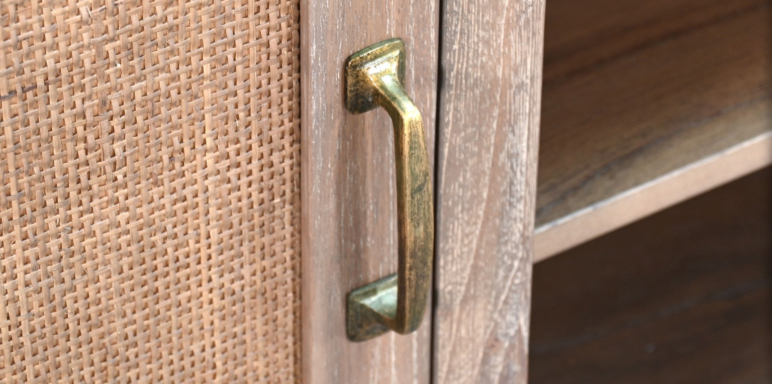 Close-up of a wooden door with a brass handle